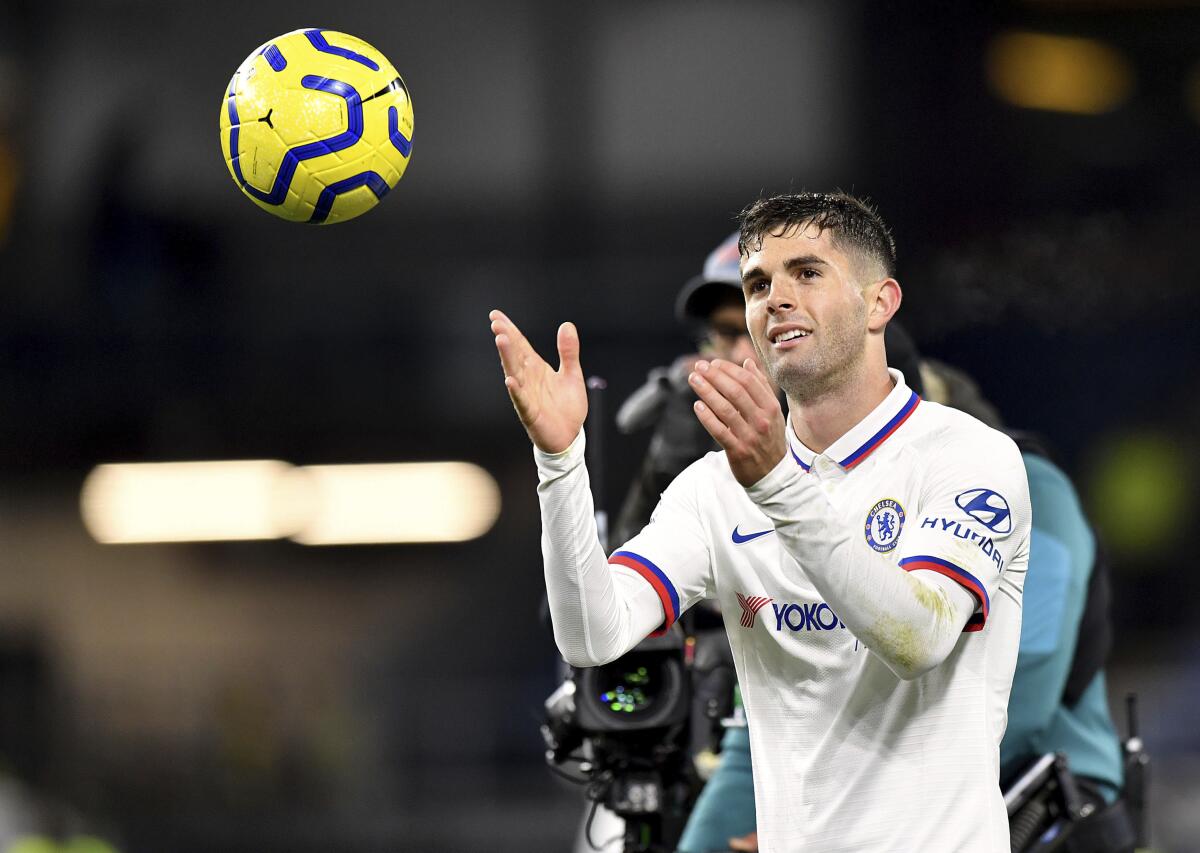 Chelsea's Christian Pulisic with the match ball after the final whistle after scoring a hat-trick during the English Premier League soccer match against Burnley at Turf Moor, Burnley, England Saturday Oct. 26, 2019. (Anthony Devlin/PA via AP)