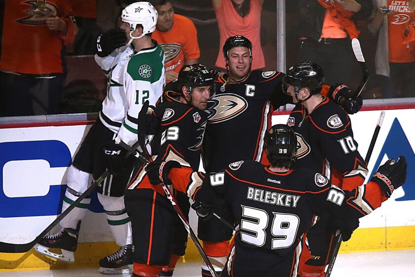 The Ducks celebrate following a goal by captain Ryan Getzlaf, top center, during the first period of Game 1 of the Western Conference quarterfinals against the Dallas Stars at Honda Center.
