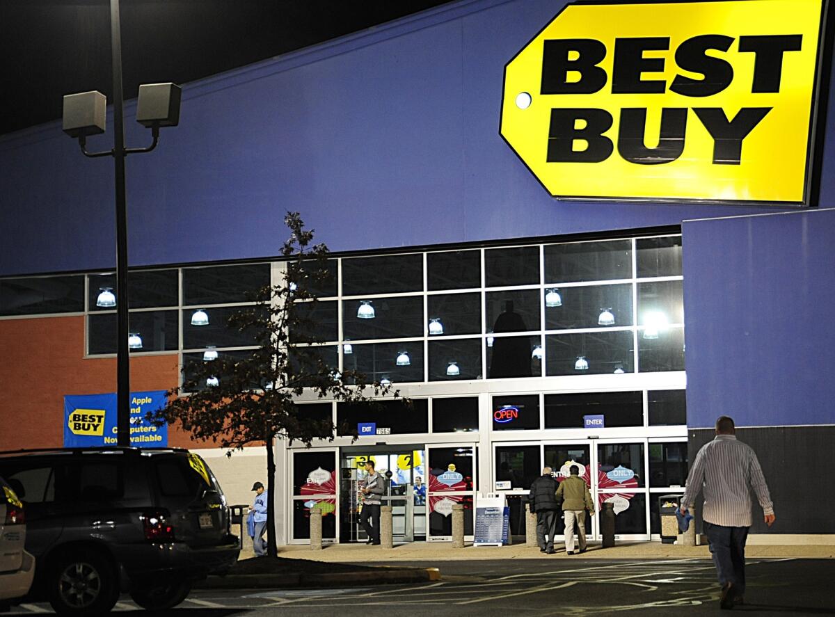 Best Buy is streamlining its operations in the U.S. and selling its stake in a joint venture in Europe. Above, a Best Buy in store in Manassas, Va.