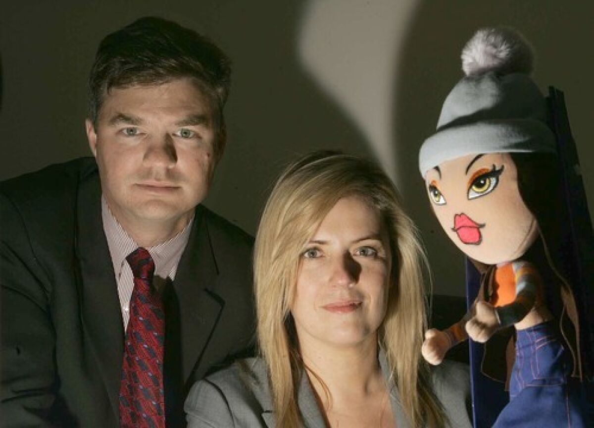 Greenberg Glusker attorneys Stephen Smith and Suann MacIsaac with a Bratz doll. The firm's first big video game case came when a client, Ubisoft, was sued by MGA, maker of Bratz.