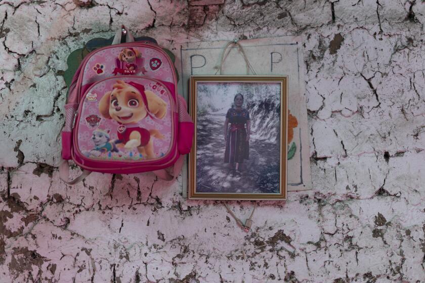 A portrait of Aracely Marroquín Coronado, who died in 2022 alongside 50 other migrants, asphyxiated in a smuggler's trailer truck in San Antonio, Texas, hangs inside a relatives' home in Comitancillo, Guatemala, March 19, 2024. The 21-year-old who had completed high school felt she had wasted her family's money in studying since she still couldn't get a professional job. (AP Photo/Moises Castillo)