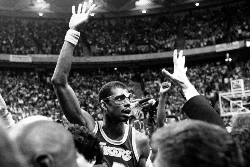 Kareem Abdul-Jabbar acknowledges the cheering fans after setting a new NBA regular season scoring record of 31,421 points during the Lakers game with the Utah Jazz on April 6, 1984 in Las Vegas. The old record was held by Wilt Chamberlain at 31,419.