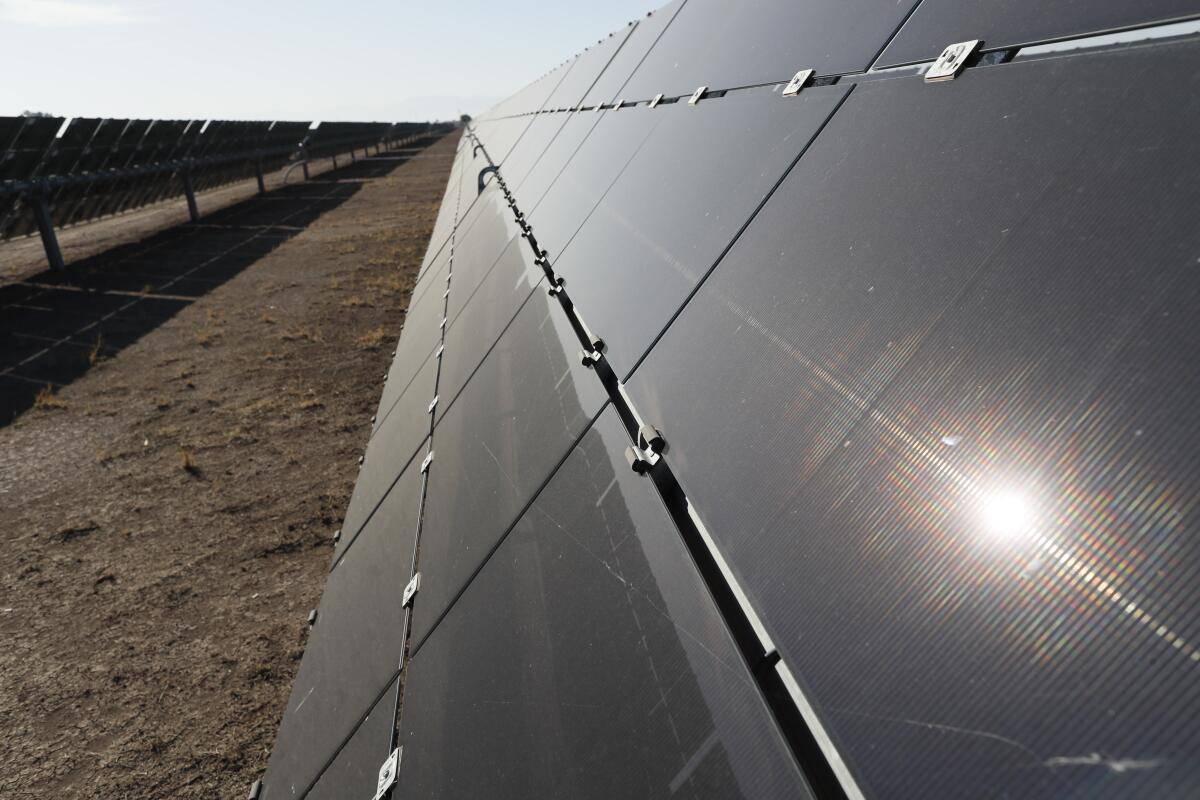 Sunlight glints off photovoltaic panels at a solar project in California's Imperial County.