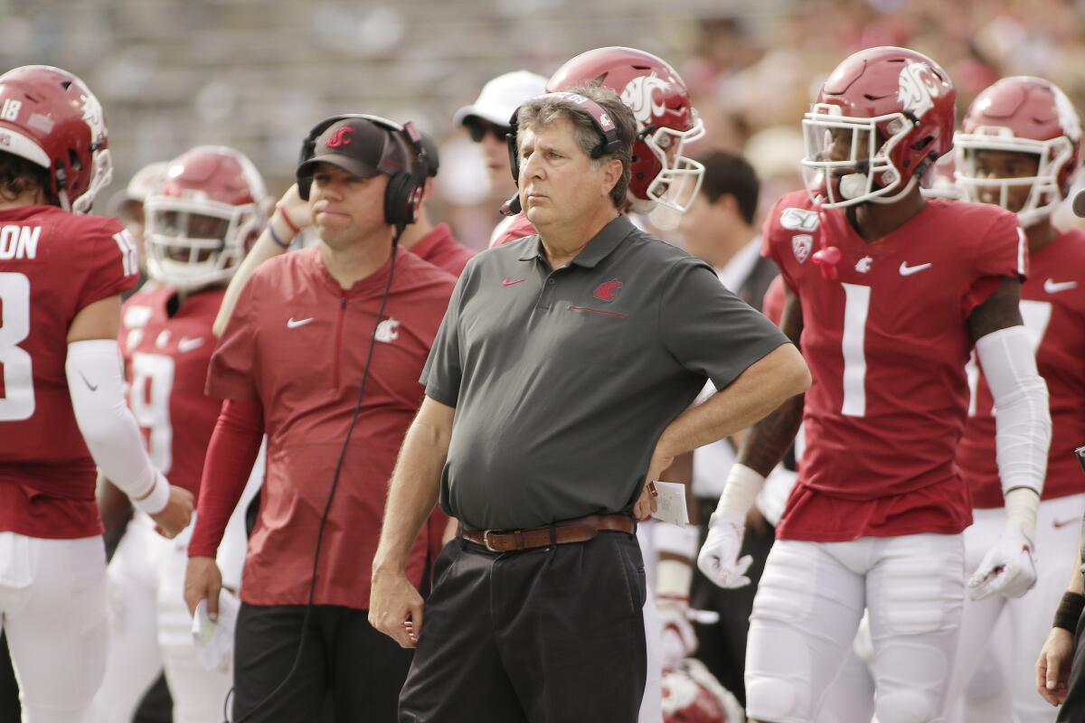 Washington State head coach Mike Leach, center, looks on during the first half against Northern Colorado in Pullman, Wash. on Sept. 7.