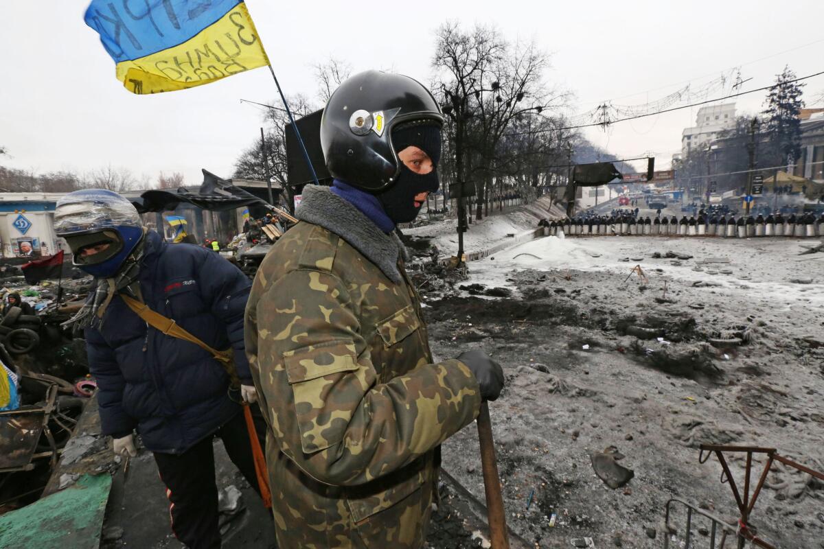 Anti-government protesters stand along barricades in Kiev, Ukraine.