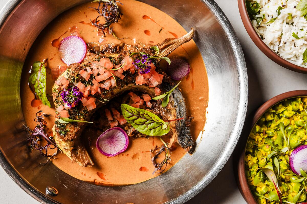 San Francisco, CA - May 20: Varuval-Crusted Hamachi Collar, coconut rice, blue lake beans, fish head gravy, black mustard at Copra Restaurant on Wednesday, May 21, 2025 in San Francisco, CA. (Carolyn Fong / For The Times)