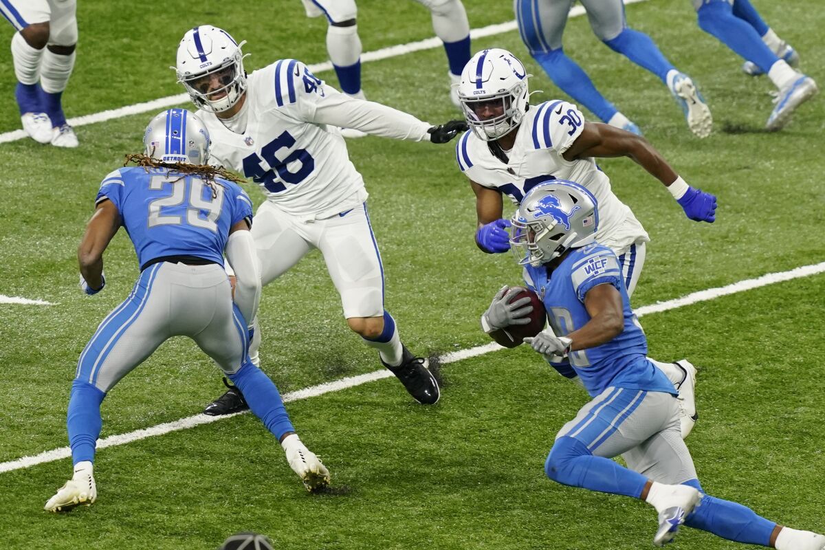 Detroit Lions running back Adrian Peterson, right, rushes during the second half of an NFL football game against the Indianapolis Colts, Sunday, Nov. 1, 2020, in Detroit. (AP Photo/Carlos Osorio)