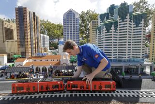 CARLSBAD, CA - MARCH 25, 2023: Master Model Builder Carter Cummings, 26, works on a LEGO version of the San Diego Trolley while in the downtown San Diego part of Miniland San Diego at Legoland in Carlsbad on Saturday, March 25, 2023. (Hayne Palmour IV / For The San Diego Union-Tribune)