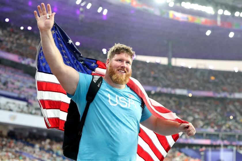 PARIS, FRANCE August 3, 2024-USA's Ryan Crouser celebrates the gold medal in shot put.