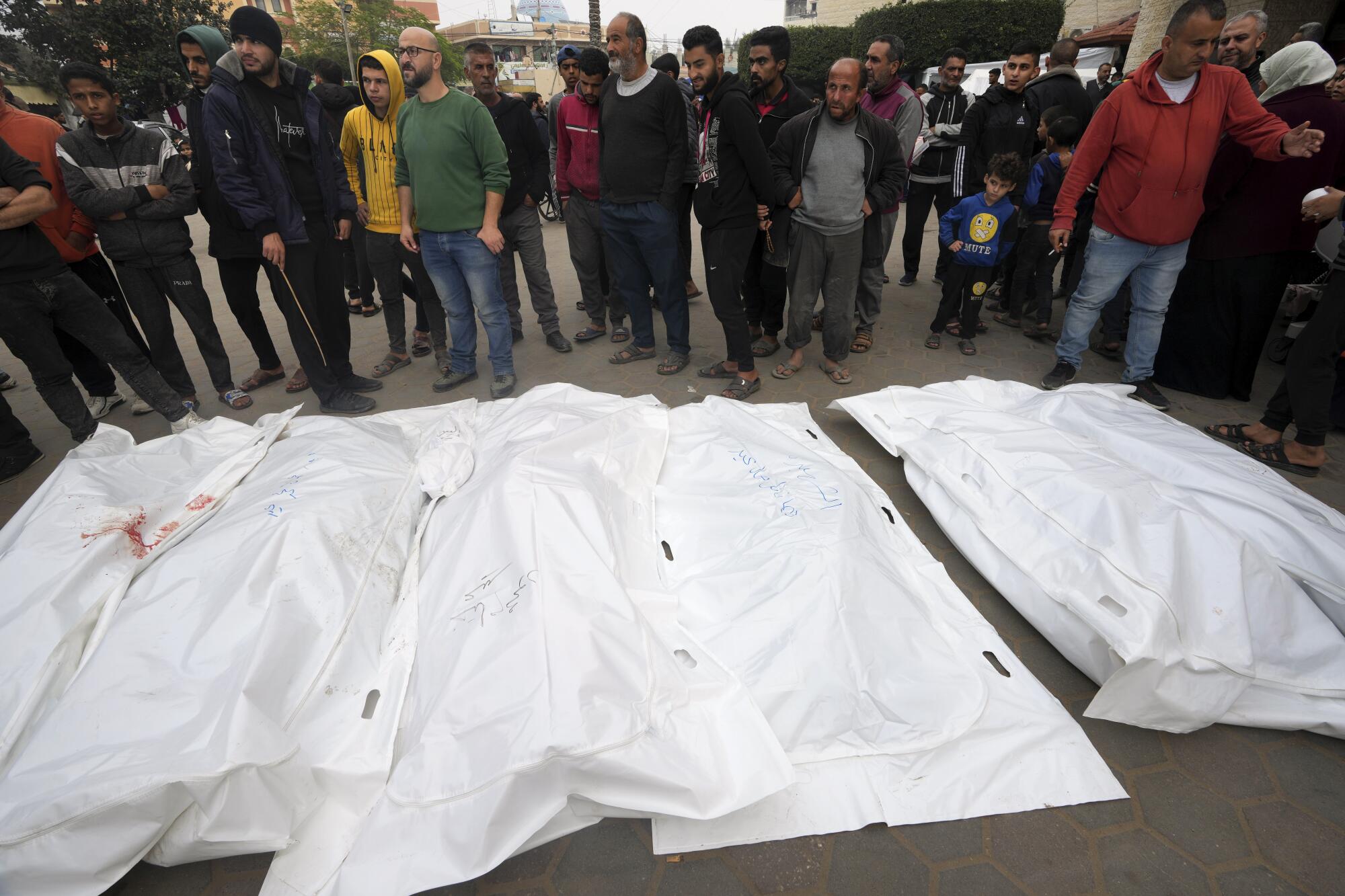 Palestinians mourn their relatives killed in the Israeli bombing of the Gaza Strip in Deir al Balah