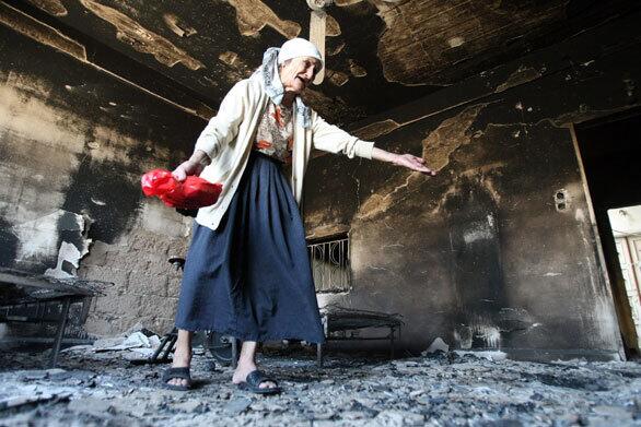 A Lebanese woman shows her burned house in the Jabal Mohsen district of the northern Lebanese city of Tripoli. Army and police moved today into battle areas in north Lebanon where two days of fierce sectarian battles killed eight people, threatening to derail an accord to end the country's political crisis.