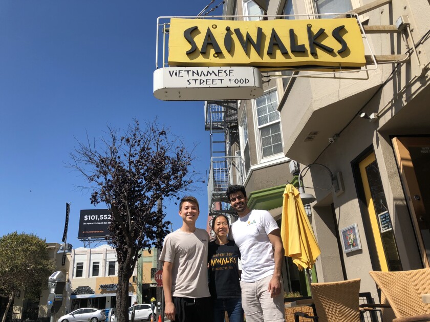 Co-founders Alec Fong (left) and Nader Khalil (right) stand with a new restaurant customer at Saiwalks in San Francisco.