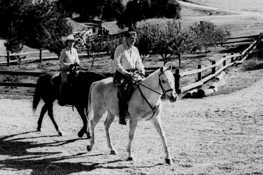 98-04-21 -- Nancy and Ronald Reagan on ranch in 1996. -- PHOTOGRAPHER: Reuters FILE-- President Reagan and his wife Nancy take a ride at their ranch, Rancho del Cielo, in Santa Barbara, Calif., in this 1982 file photo. Since announcing in 1994 that the former president, now 87, was battling Alzheimer's disease, the Reagans have made their Bel-Air home their primary residence, leaving the ranch vacant. A group of young Republicans is buying the mountaintop ranch for use as a training center for future GOP leaders. (AP Photo/File)
