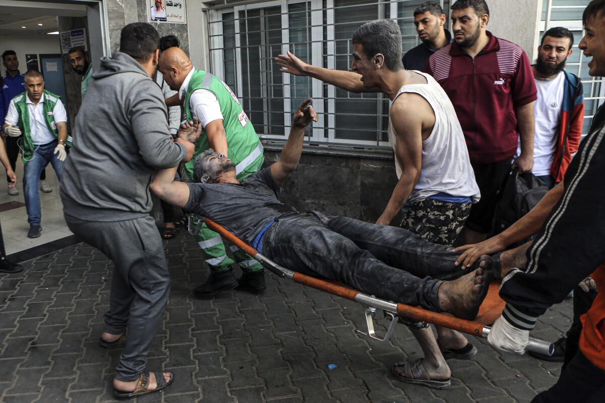 An injured man is carried on a stretcher