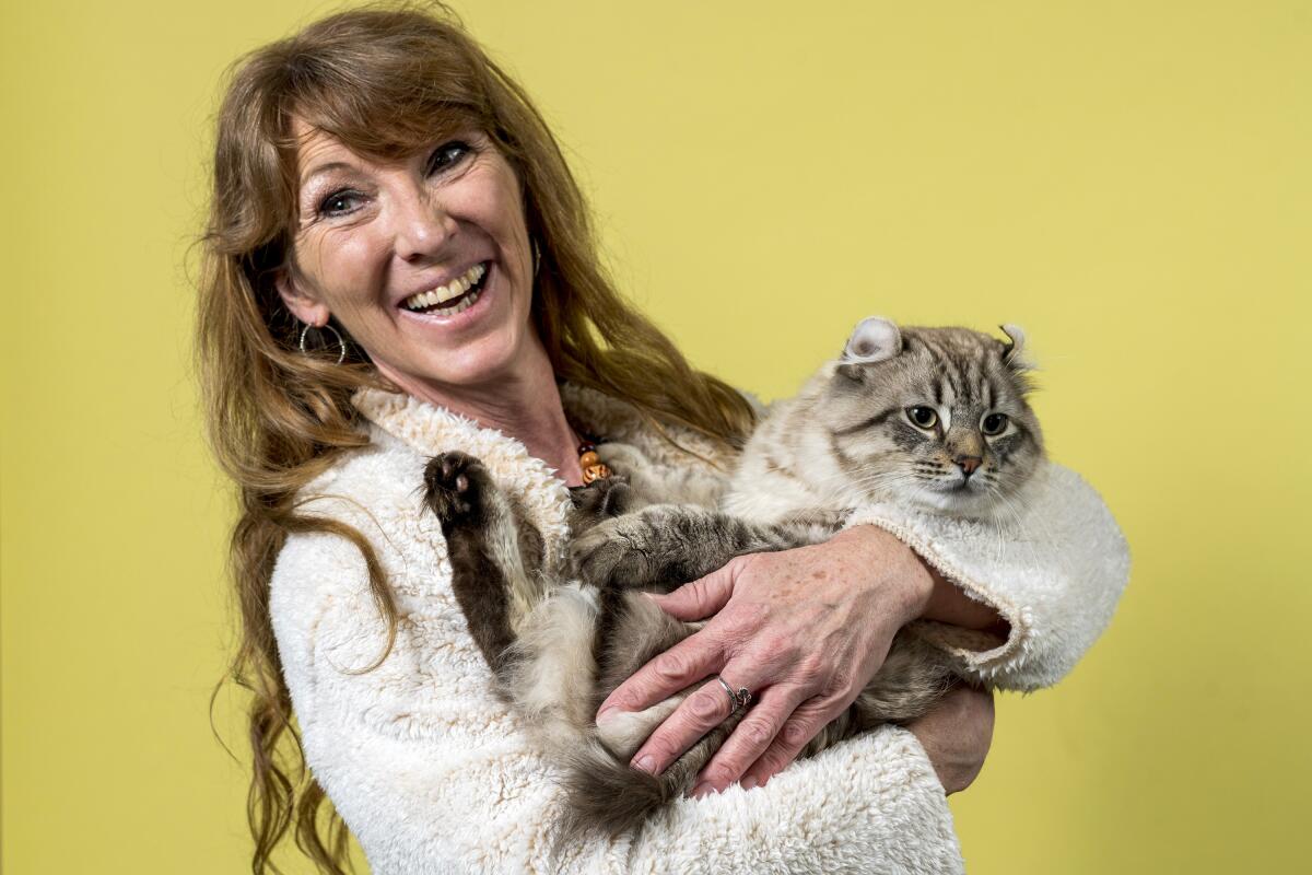 Bobbi Temple holds her Highlander cat named Troy Sloane.