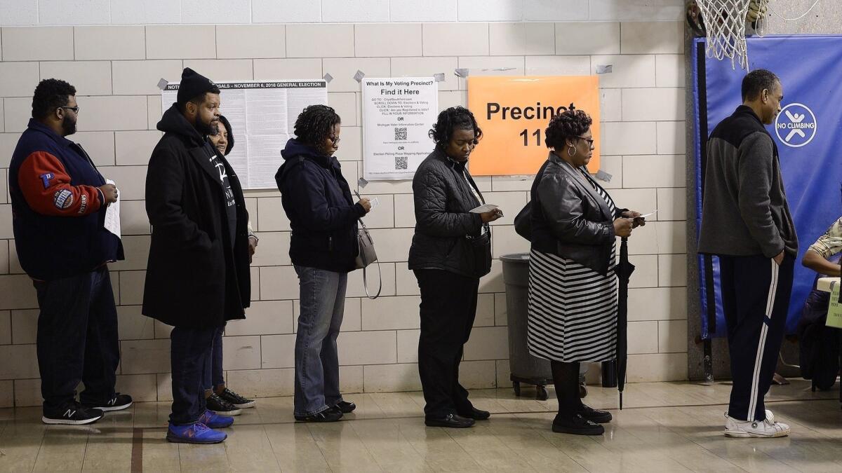 Voters wait in line on election day in 2018.