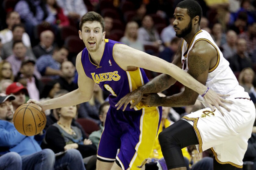 Lakers forward Ryan Kelly tries to drive past Cavaliers forward Earl Clark in the second quarter Wednesday night in Cleveland.