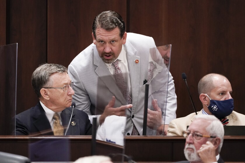 FILE - Rep. Jeremy Faison, R-Cosby, center, talks with Rep. Dan Howell, R-Georgetown, left, during a meeting, Aug. 11, 2020, in Nashville, Tenn. A top Tennessee House Republican lawmaker has apologized for losing his temper and being ejected from watching a high school basketball game after getting into a confrontation with a referee, including a brief gesture at pulling down the official's pants that is visible in video footage of the game. On Tuesday, Jan. 4, 2022 Rep. Jeremy Faison, 45, posted on Twitter that he “acted the fool tonight and lost my temper on a ref.” (AP Photo/Mark Humphrey, file)