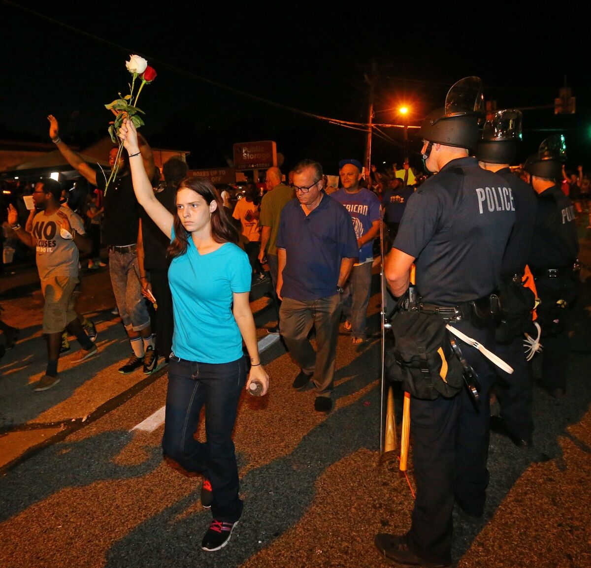 Demonstrators march through Ferguson, Mo., on Tuesday night.