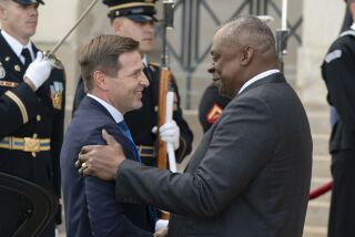 FILE - Estonia's Defense Minister Hanno Pevkur, left, is greeted by Secretary of Defense Lloyd Austin during an honor cordon ceremony, upon his arrival at the Pentagon, Tuesday, Oct. 18, 2022, in Washington. NATO member and Russia’s neighbor Estonia is boosting its defense capabilities by acquiring an advanced U.S. rocket artillery system. Estonian defense officials said Saturday, Dec. 3, 2022 that the deal with the U.S. worth more than $200 million is the Baltic country’s largest arms procurement project ever. (AP Photo/Alex Brandon, File)