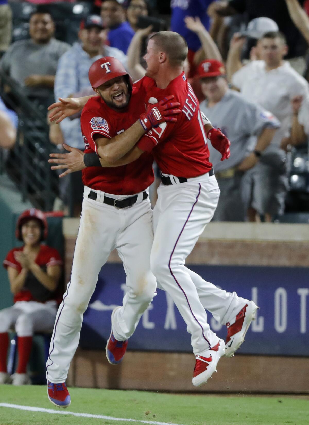 Isiah Kiner-Falefa, left, celebrates with Texas Rangers teammate Scott Heineman.