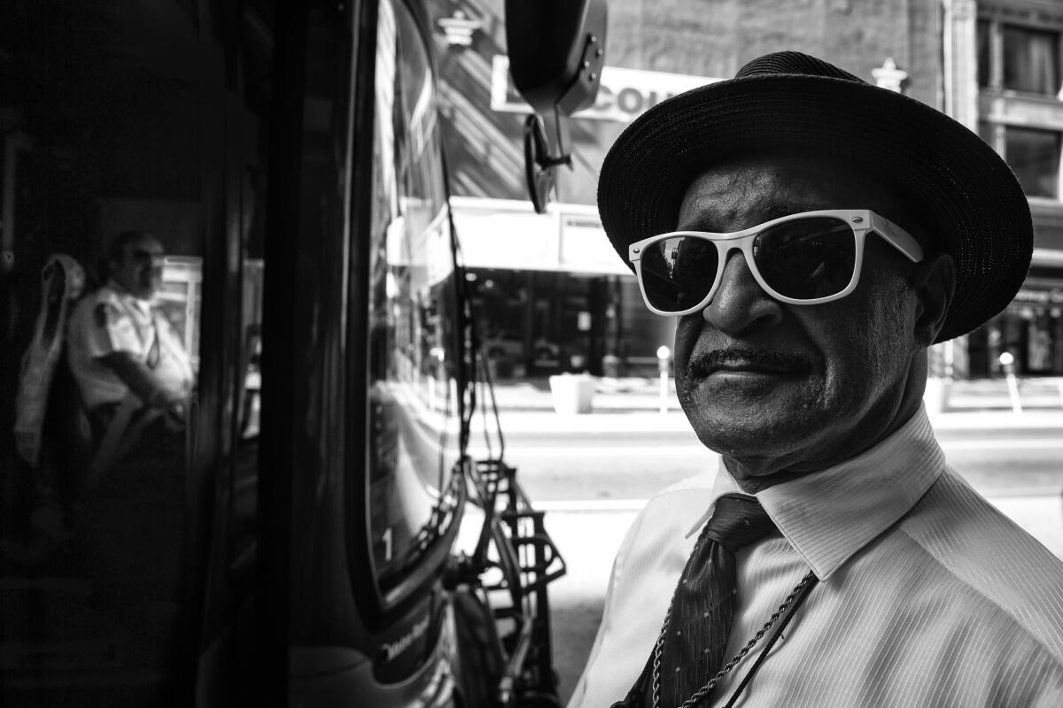 A self-proclaimed bus stop minister in front of the Broadway Mall.