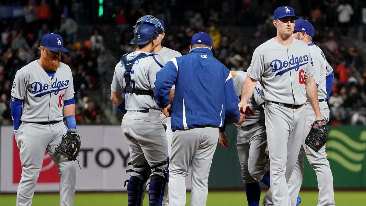 Manager Dave Roberts of the Dodgers pulls pitcher Ross Stripling (68) out of the game.