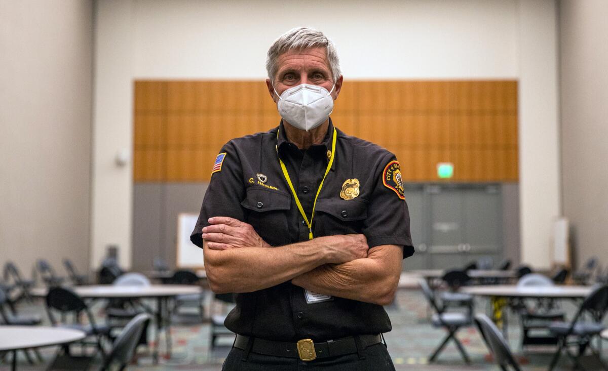 Deputy Fire Chief Chris Heiser poses for a photograph inside a large room at the San Diego Convention Center.