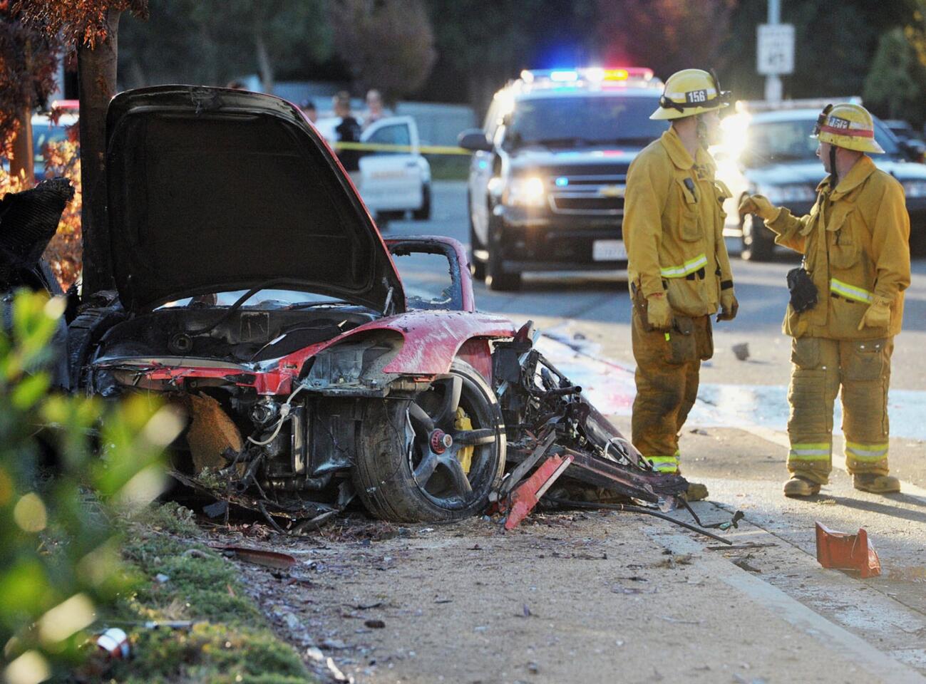 Firefighters and sheriff's deputies work near the crash scene in the 28300 block of Rye Canyon Loop on Nov. 30.