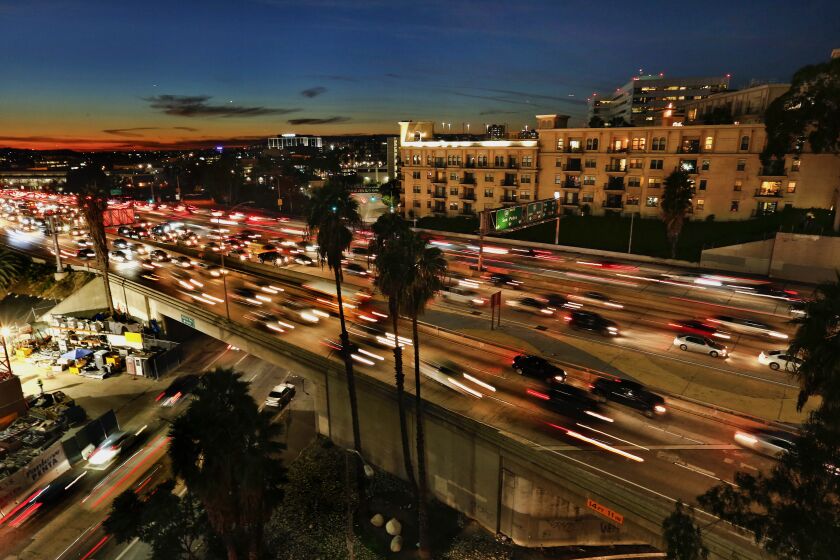 LOS ANGELES, CA-FEBRUARY 1, 2017: Motorists make their way along the 110 freeway in downtown Los Angeles, past the Medici Apartments, one of Geoffrey H. Palmer’s massive Italianate apartment complexes overlooking downtown freeways. He has built thousands of units and is planning more. (Mel Melcon/Los Angeles Times)