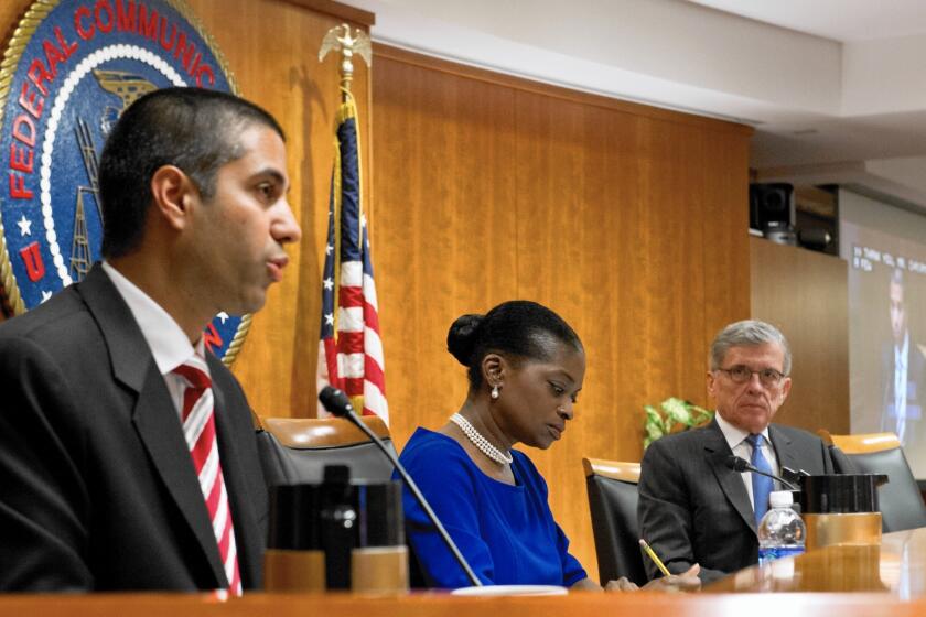 After listening to FCC Chairman Tom Wheeler, a Democrat, and Republican member Ajit Pai spar over net neutrality last week, some lawmakers wondered if a compromise could be reached. Above, Pai speaks as Commissioner Mignon Clyburn and Wheeler look on at an FCC meeting last year.
