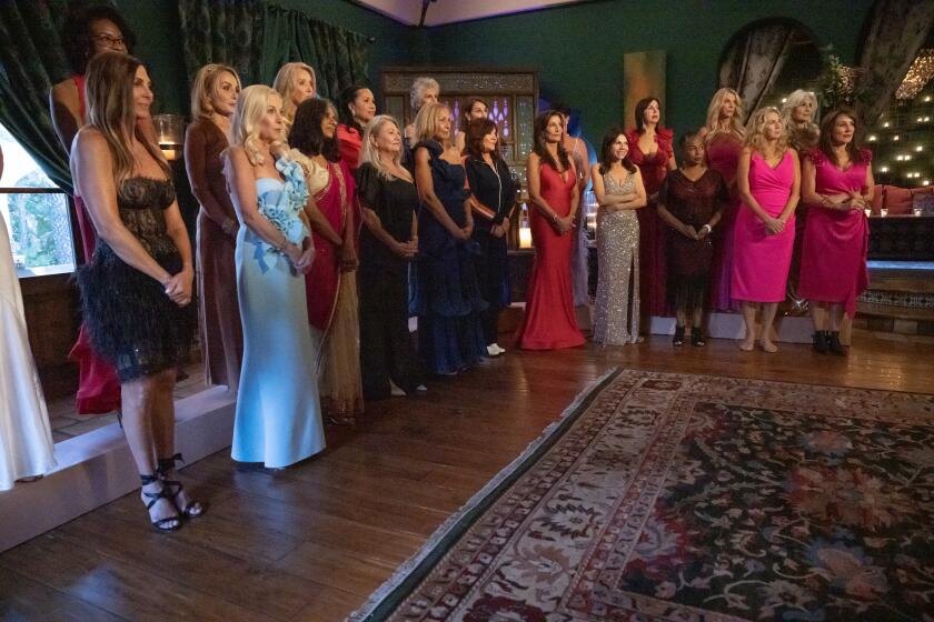 A group of women in evening gowns standing in a  reception room