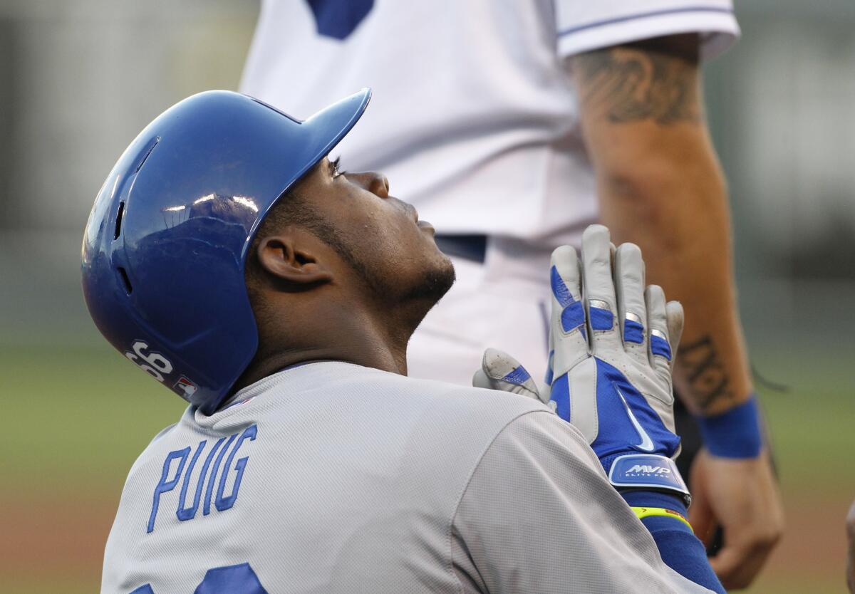 Dodgers' Yasiel Puig reacts after hitting a triple in the third inning of a game against the Kansas City Royals on Wednesday.