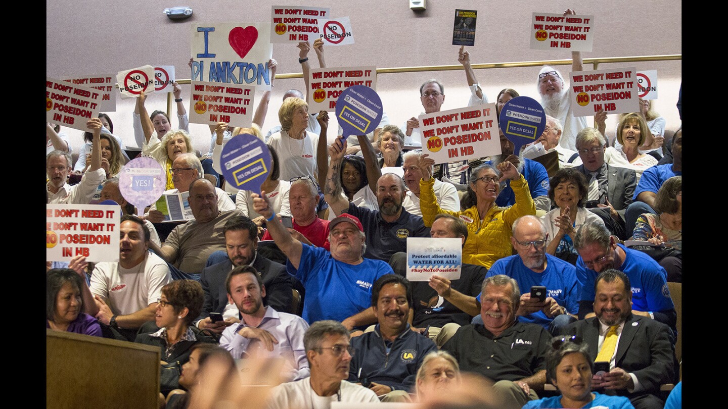 Detractors and supporters of the proposed Poseidon desalination facility voice their opinions during a California State Lands Commission meeting at Huntington Beach City Hall on Thursday.