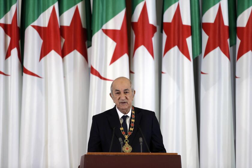 FILE - In this Thursday, Dec. 19, 2019 file photo, Algerian president Abdelmadjid Tebboune delivers a speech during an inauguration ceremony in the presidential palace, in Algiers, Algeria. Still recovering from COVID-19, Algeria's president suddenly reappeared Sunday Dec. 13, 2020, after nearly two months out of the public eye, saying in a video message that it may still be several more weeks before he is fit enough to return to his North African country. (AP Photo/Toufik Doudou, File)