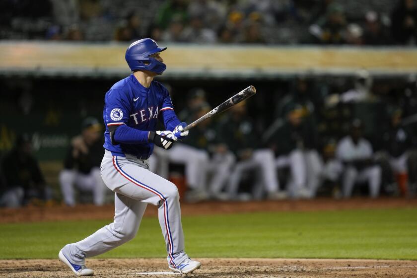 Texas Rangers' Corey Seager watches his three-run home run against the Oakland Athletics during the eighth inning of a baseball game Monday, May 6, 2024, in Oakland, Calif. (AP Photo/Godofredo A. Vásquez)