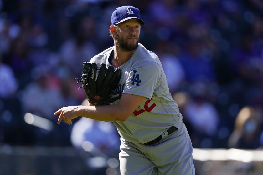 Dodgers pitcher Clayton Kershaw follows through against the Colorado Rockies.