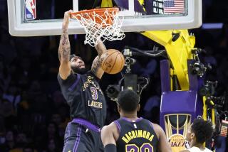 Laker Anthony Davis dunks in front of teammate Rui Hachimura and the Jazz's Ochai Agbaji