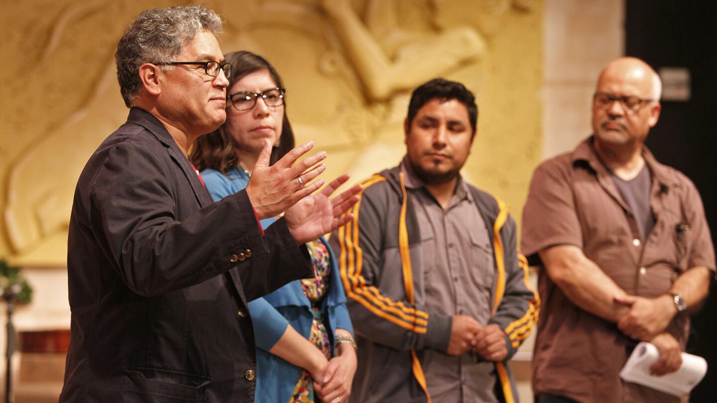 From left: Jose Cruz Gonzalez, playwright, Sara Guerrero, project director, Moises Vazquez, Latino Health Access, and Armando Molina, play director, address the audience before Santa Ana community members took the stage during a reading at Santa Ana College.