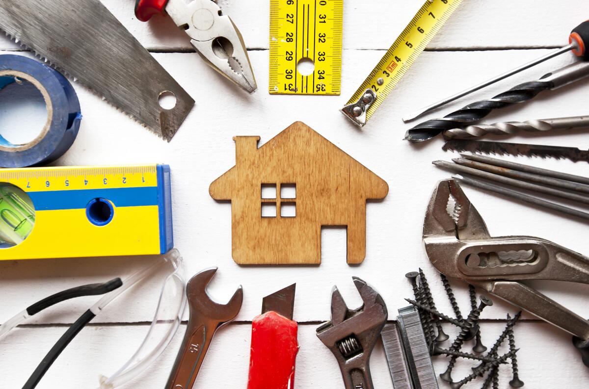 Tools surround an image of a house