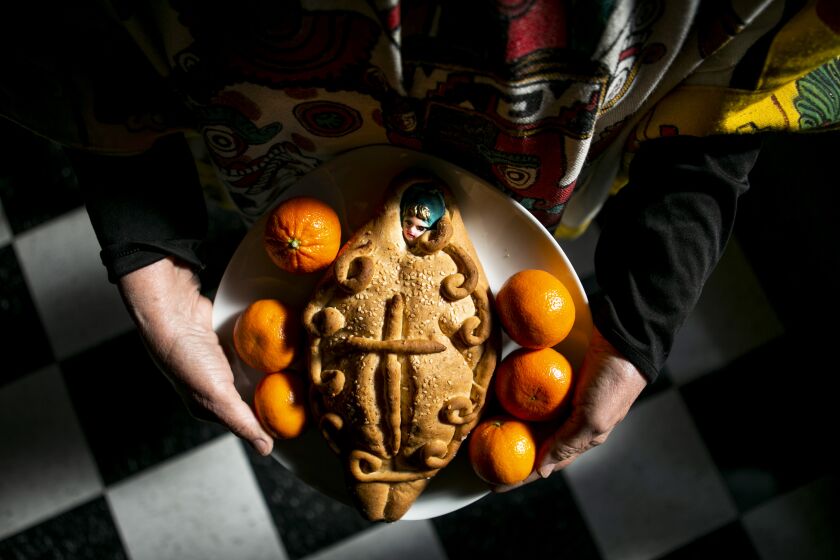 VENICE, CA - OCTOBER 22: Marta Ramirez-Oropeza, a UCLA professor and expert on Dia de los Muertos holds an offering to be put on the Dia de los Muertos altar at the Social and Public Art Resource Center in Venice, which for many years has hosted Day of the Dead celebrations on Friday, Oct. 22, 2021 in Venice, CA. (Jason Armond / Los Angeles Times)