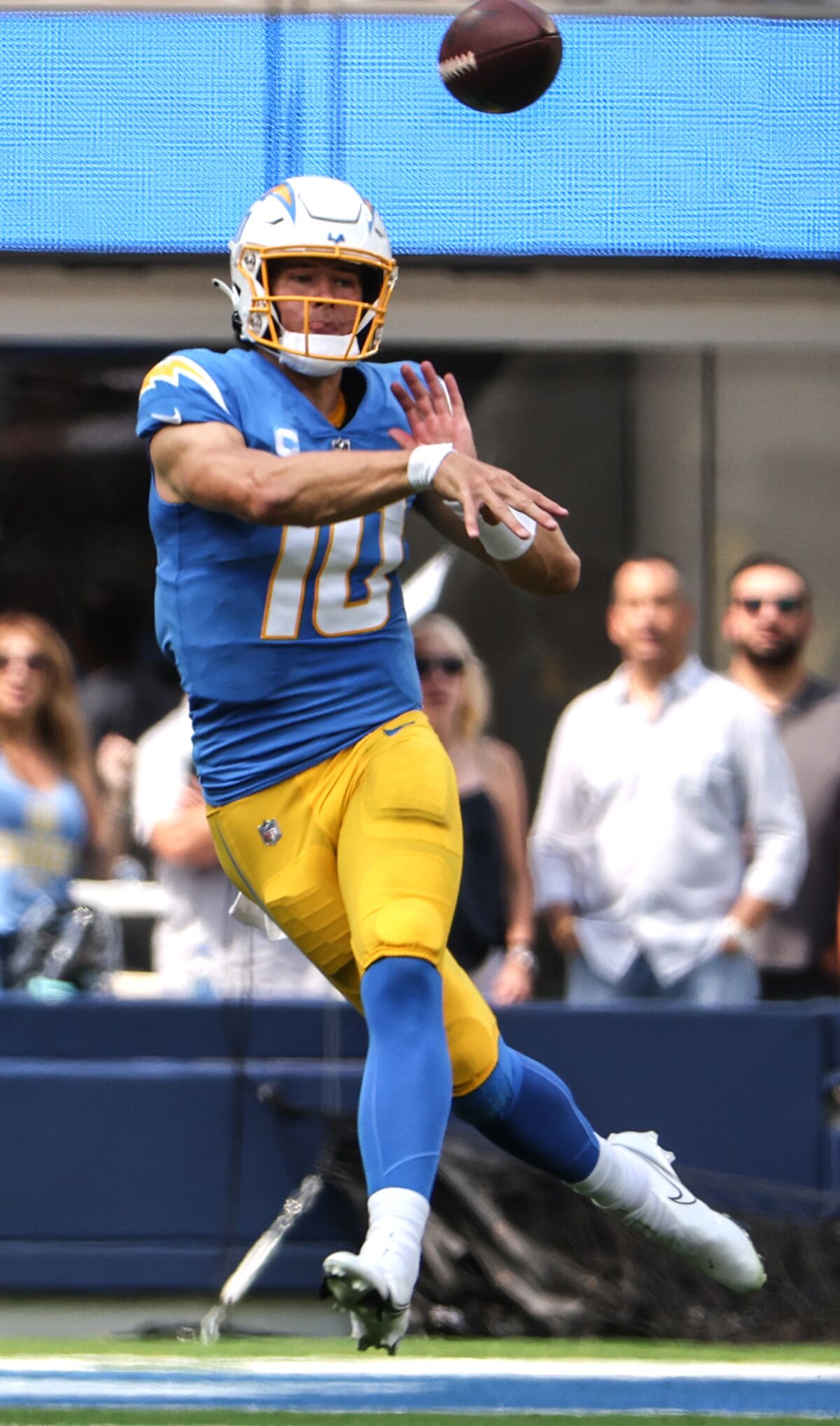 Chargers quarterback Justin Herbert (10) throws while on the run against the Las Vegas Raiders.
