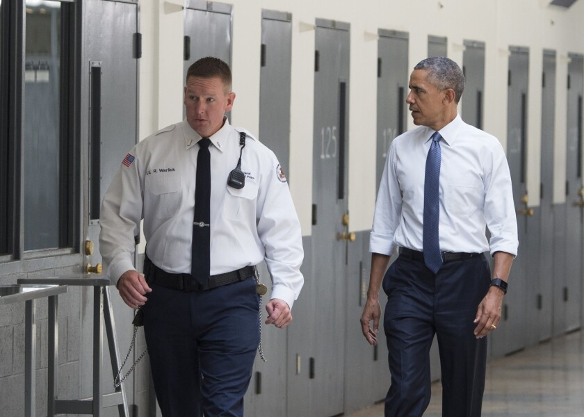 President Obama, with a correctional officer, tours El Reno Federal Correctional Institution in Oklahoma on Thursday.