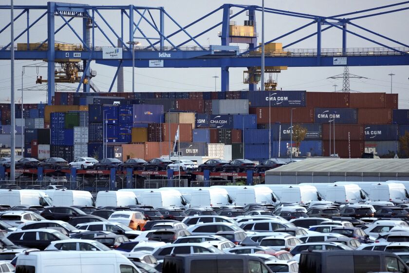 FILE -- Cars and containers are pictured at the 'duisport logport' logistics center at the river Rhine in Duisburg, Germany, Friday, Oct. 28, 2022. Official figures show that Germany’s economy shrank by 0.2% in the fourth quarter compared with the previous three-month period. The performance by Europe’s biggest economy was worse than expected. (AP Photo/Michael Sohn,file)