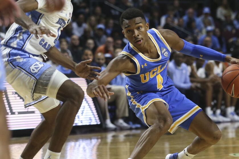 UCLA's Jaylen Hands (4) moves the ball against North Carolina during the second half of an NCAA college basketball game Friday, Nov. 23, 2018, in Las Vegas. (AP Photo/Chase Stevens)
