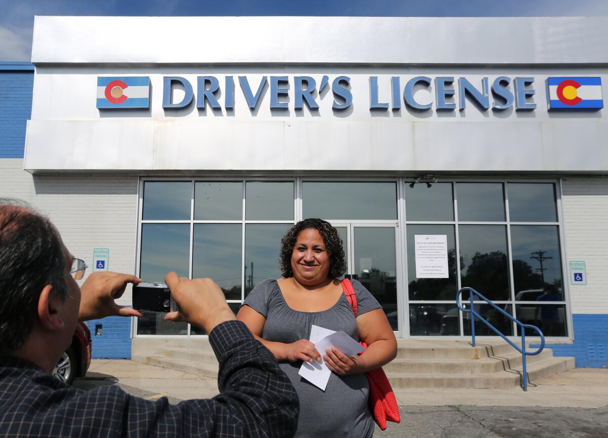 Rosalva Mireles is photographed Friday in Denver by Jesus Sanchez of Spanish-language newspaper El Commercio after Mireles applied for her driver's license.
