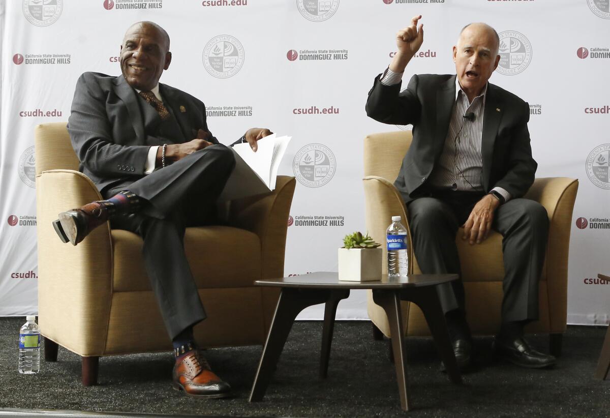 State Sen. Steven Bradford (D-Compton), left, and Gov. Jerry Brown talk about funding for projects under the state transportation bill, SB1, at Cal State Dominguez Hills in Carson.