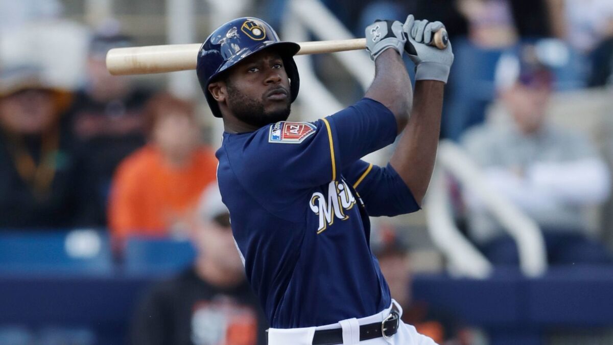 The Brewers' Lorenzo Cain bats during the first inning of a spring training baseball game against the San Francisco Giants, Wednesday, Feb. 28, 2018, in Maryvale, Ariz.