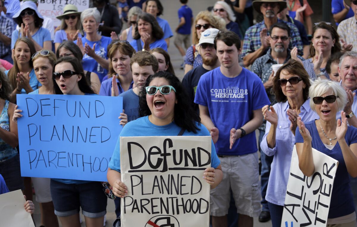 Antiabortion activists rally outside the Texas Capitol in Austin. A new study links the defunding of Planned Parenthood and other family planning clinics in the state with a rise in births among low-income women.