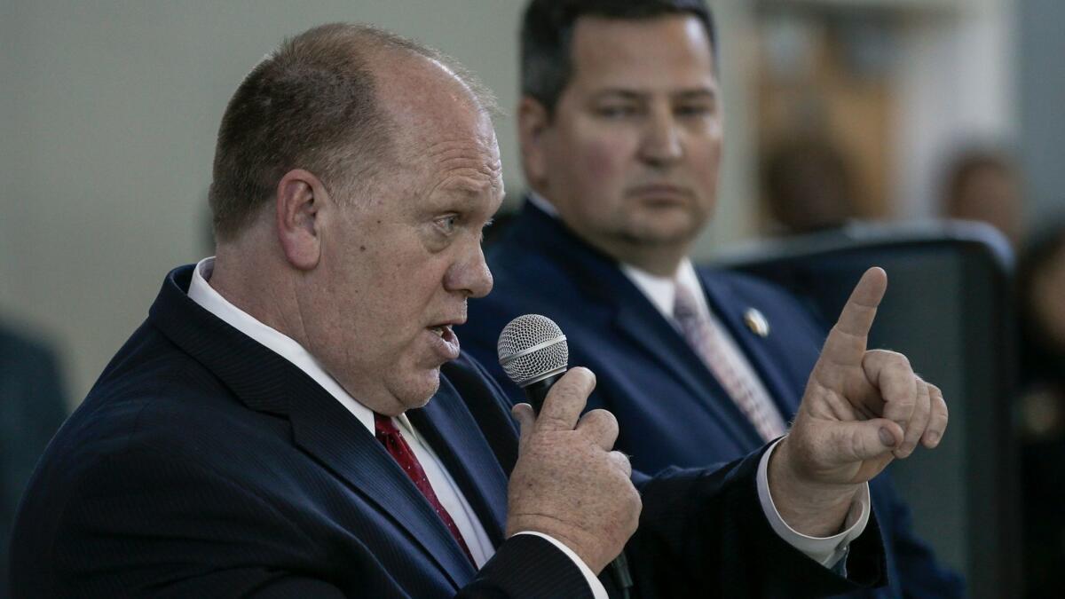 Hundreds of Sacramento residents protested, listened and shouted while acting ICE Director Thomas Homan, left, and Sacramento County Sheriff Scott Jones held a community forum about immigration enforcement..